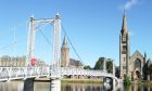 Picture by SANDY McCOOK  19th September.
Inverness File Pics.   The pedestrian Greig Street Bridge over the River Ness in Inverness while also in the photograph on the right is the Inverness Old High Church.