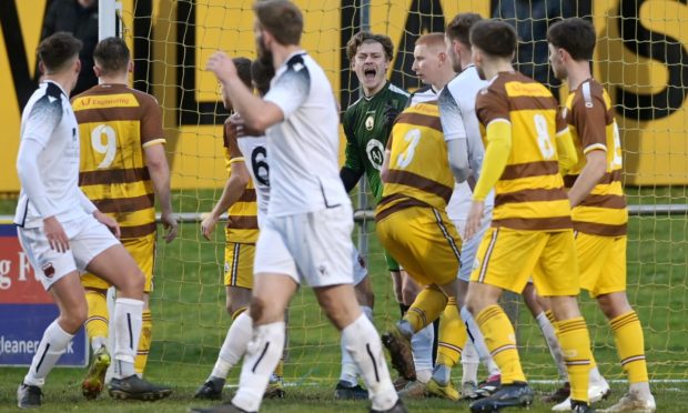 Wick players celebrate their second goal in the Scottish Cup win over Benburb, which was scored by Gordon MacNab, right
