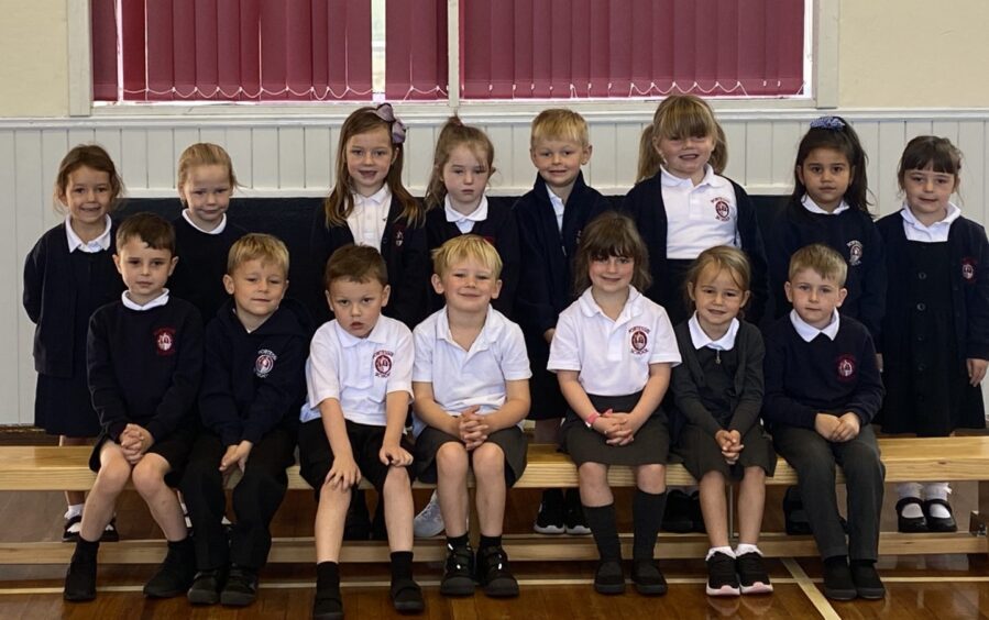 First class of 2023 at Portessie Primary School in moray in two rows in the gym hall
