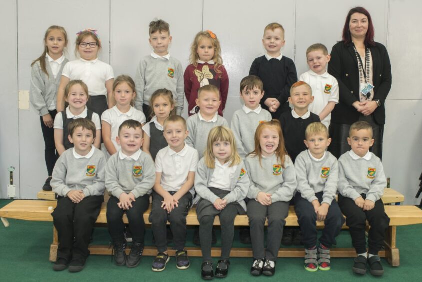 Class P1K at Quarryhill Primary School with their teacher next to them