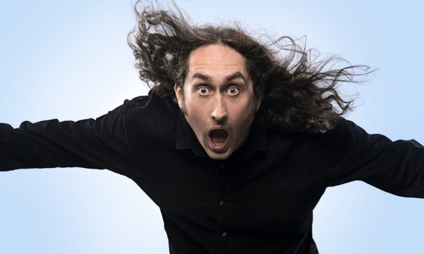 Ross Noble jumping in the air