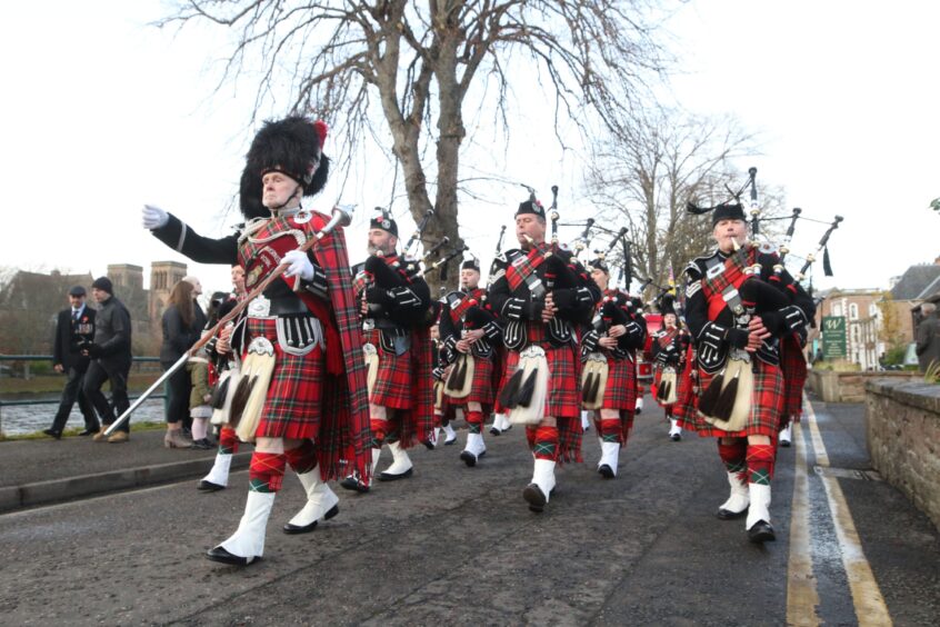 A pipe band marches in a Remembrance Sunday parade in Inverness. Image: Andrew Smith.