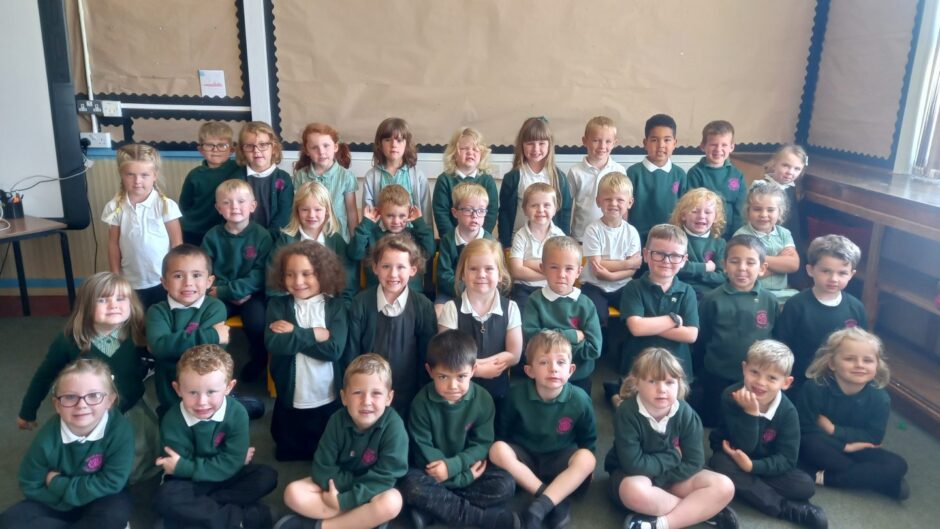 Classes P1K and P1K in Rosebank Primary in Nairn. They are pictured in four long rows in a classroom