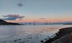 The Kessock Bridge with the sun rising behind.