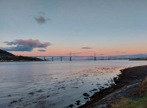 The Kessock Bridge with the sun rising behind.