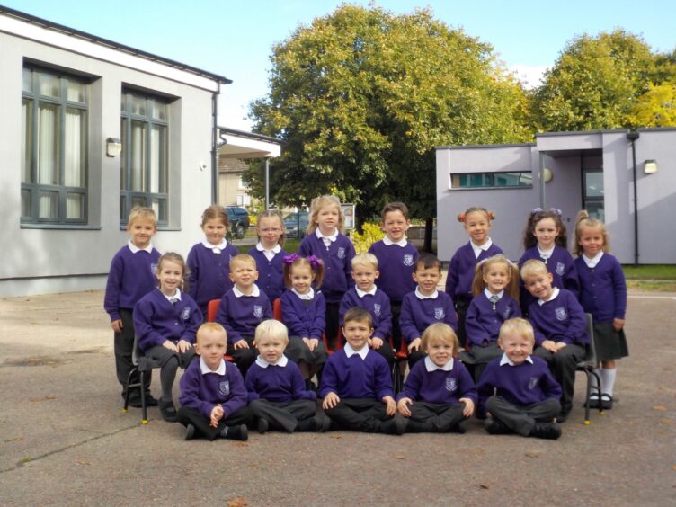 Class P1M at Seafield Primary School, in three rows outside the school