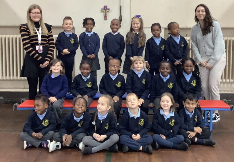 First class of 2023 at St Peter's School in Aberdeen with two teachers. The pupils are in three rows of six