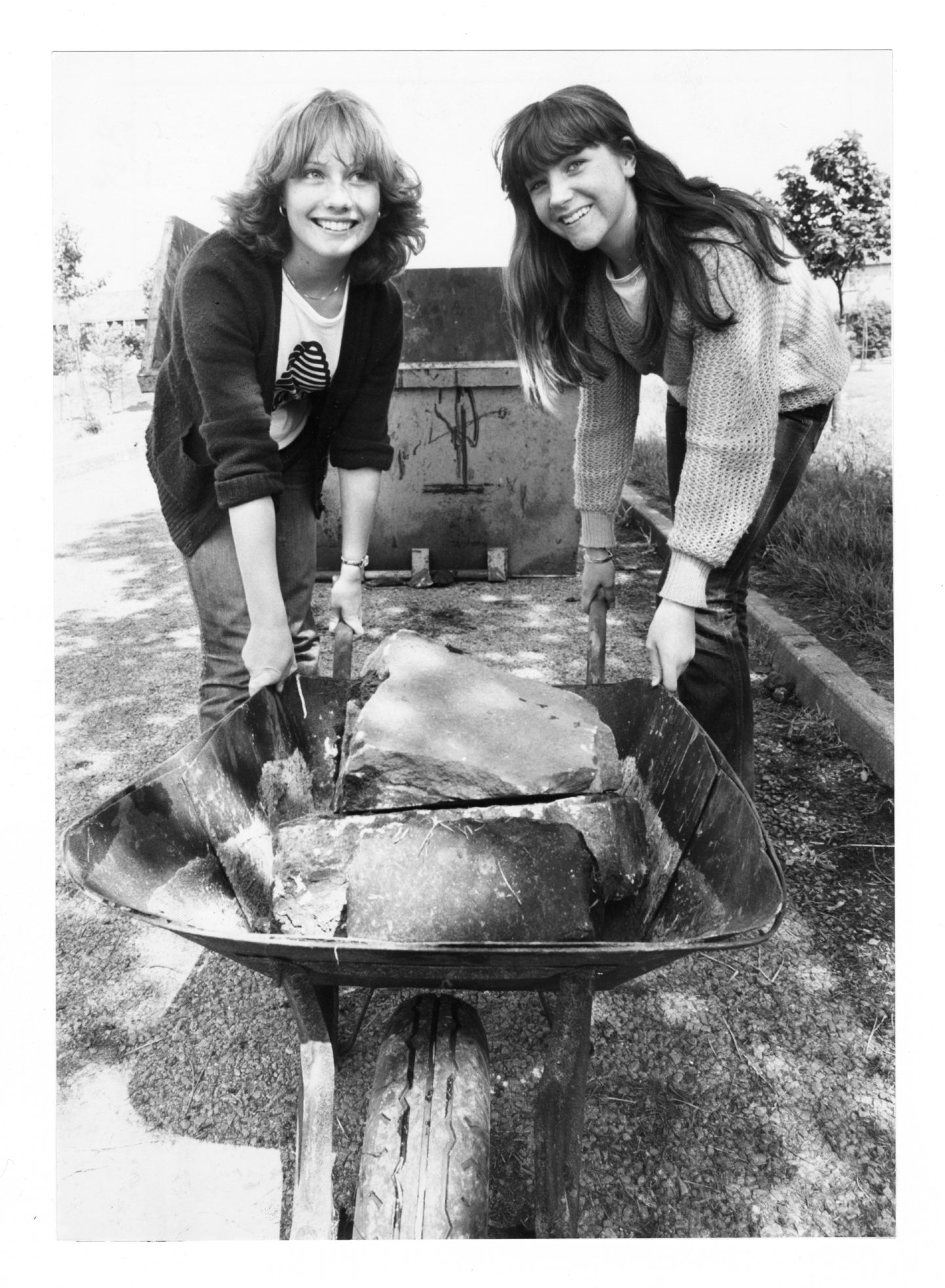 Smiles from Angela Manson and Paula Hepburn, both 15, as they press on with their share of the work in the community project in 1981.