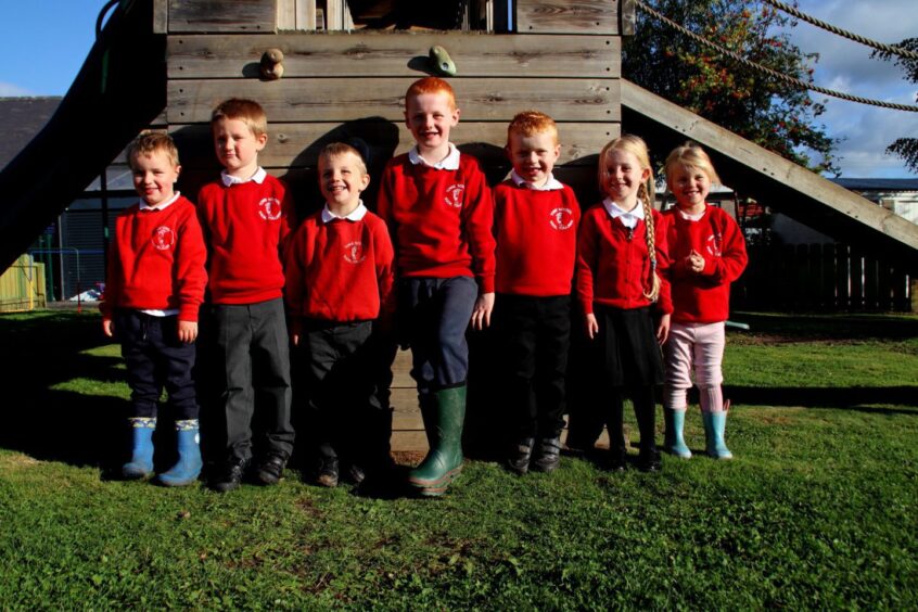 Seven pupils standing in the playground at Towie School