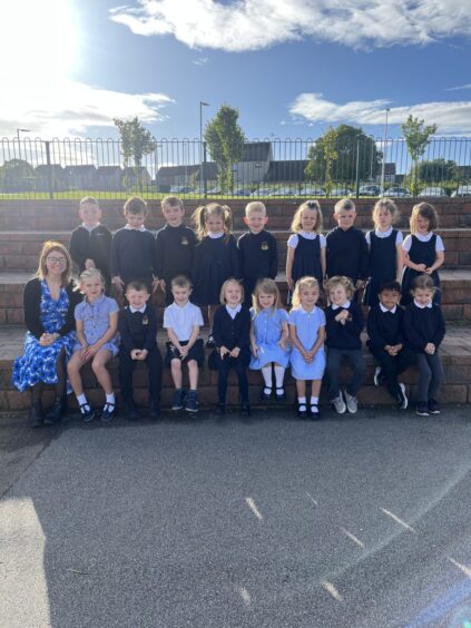 P1B outside Turriff Primary with their teacher Miss Marr