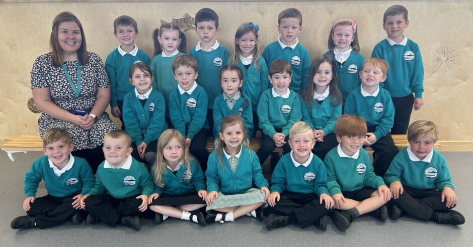 Class P1A at Uryside School arranged in rows with their teacher Miss Anderson