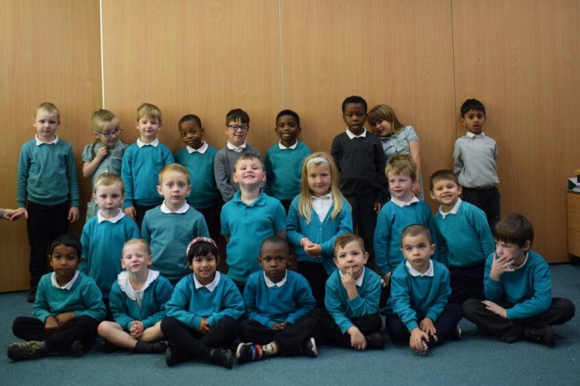 Mrs Gallagher's class P1NG from Walker Road School in aberdeen, smiling at the camera for their first class 2023 photo
