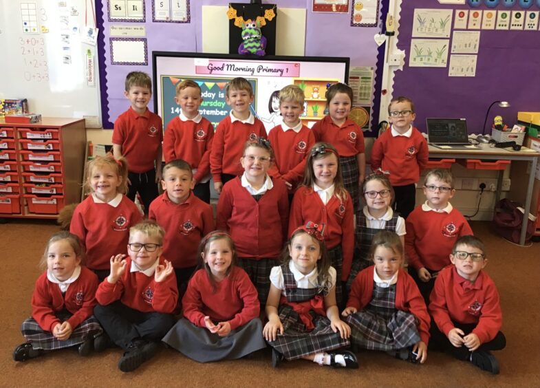 First class of 2023 at Whitehills School in Aberdeenshire arranged in rows in their classroom