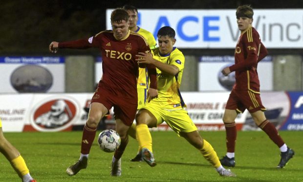 Aberdeen's Findlay Marshall, left, tries to hold off Max Barry of Buckie Thistle. Pictures by Kenny Elrick/DCT Media