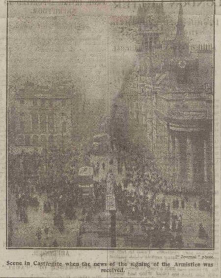 Photograph printed in the Press and Journal in 1918 of crowds gathering in Castlegate when news of the signing of the Armistice was received.