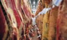 An ABP employee examines carcasses in a cold store at one of the company’s meat processing plants.