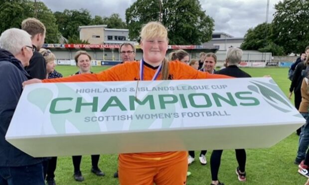 Sophia Golebiewski holding a champions banner