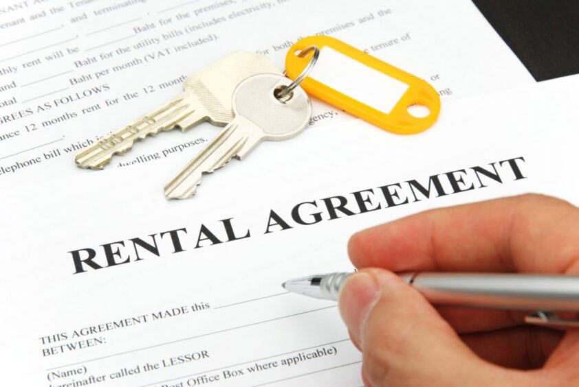 rental agreement form with signing hand and keys.