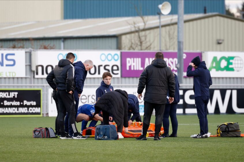 Medical team treating Spartans forward Becky Galbraith's injury on the pitch during their game against Aberdeen Women on Sunday.