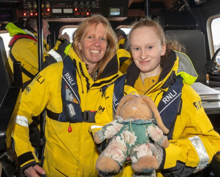 Emma Cato and her mother Rachel with the lifeboat rabbit that had comforted her big sister Abbie on the lifeboat 18 years ago.