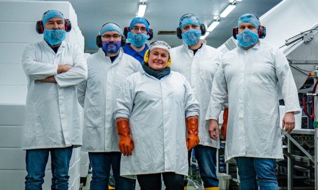 Scottish Sea Farms head of processing operations Donald Buchanan with staff in Lerwick.