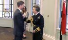 Peterhead harbourmaster Ewan Rattray being presented with his Merchant Navy Medal by the Princess Royal.