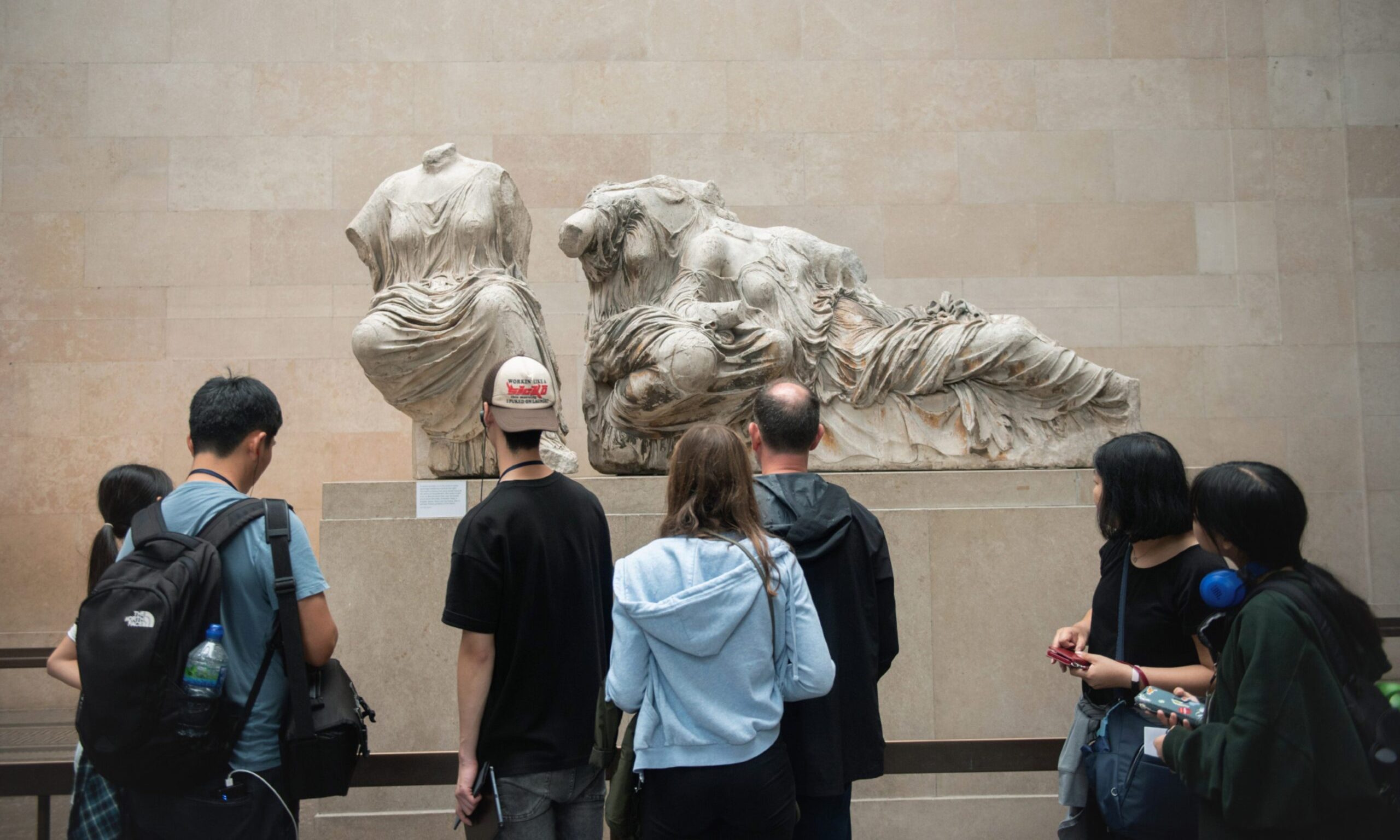 Tourists looking at Elgin Marbles in British Museum. 