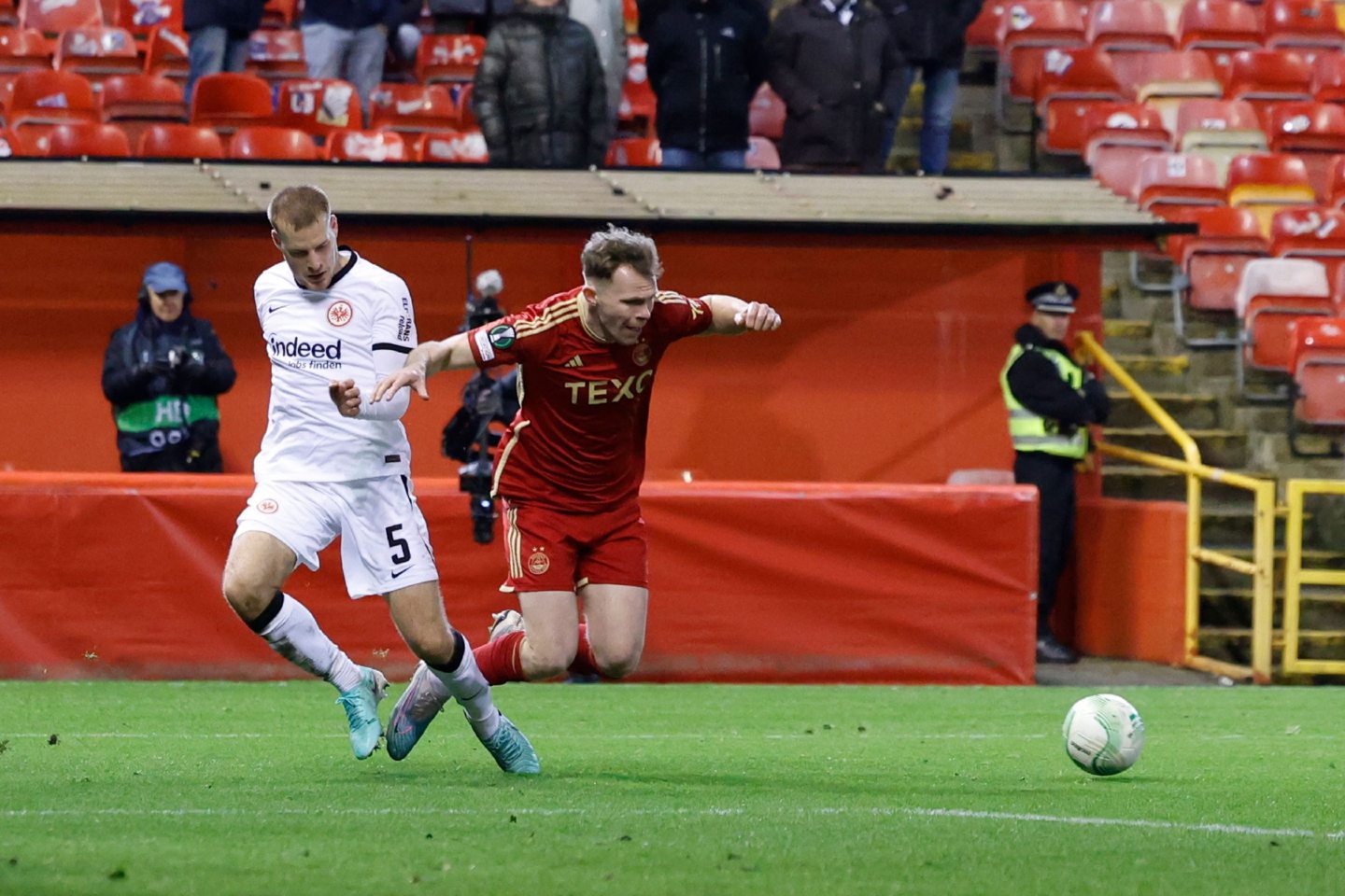 Nicky Devlin of Aberdeen goes down in the box during the Europa Conference League defeat of Eintracht Frankfurt at Pittodrie Stadium. Image: Shutterstock