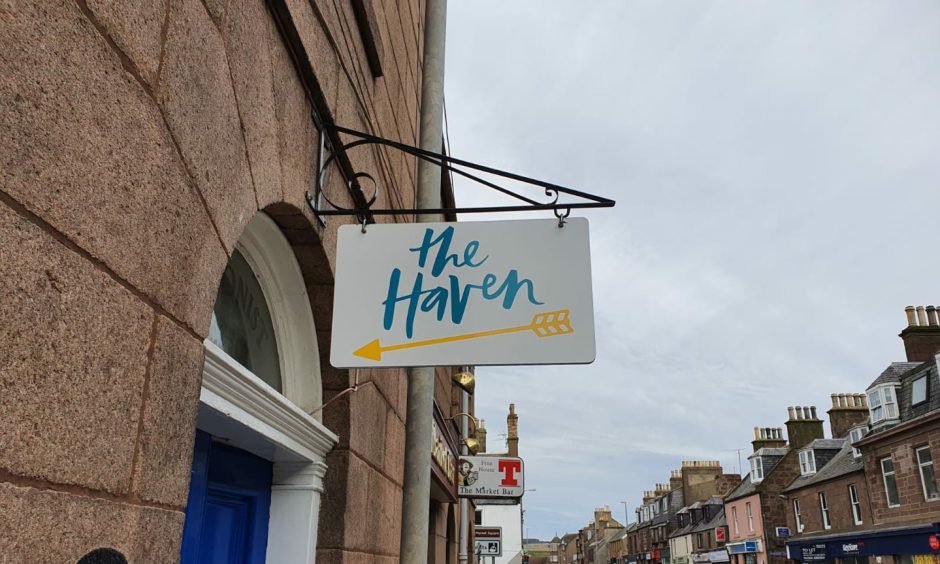 The Haven sign outside blue door 