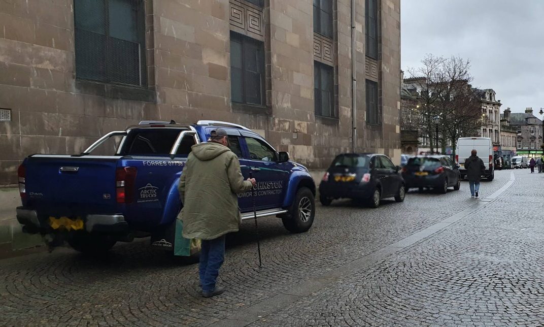 Cars parked outside St Giles Church in Elgin. 
