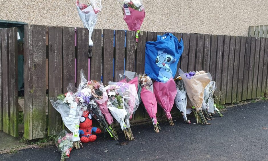 Flowers on the street at fence outside Kiesha Donaghy's flat.