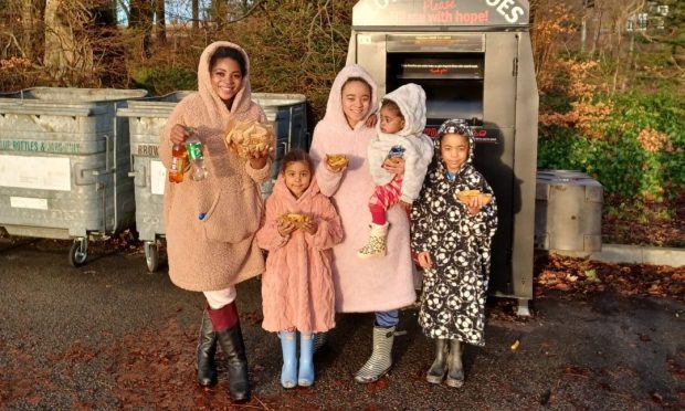 Caroline Roberts standing next to four of her children.