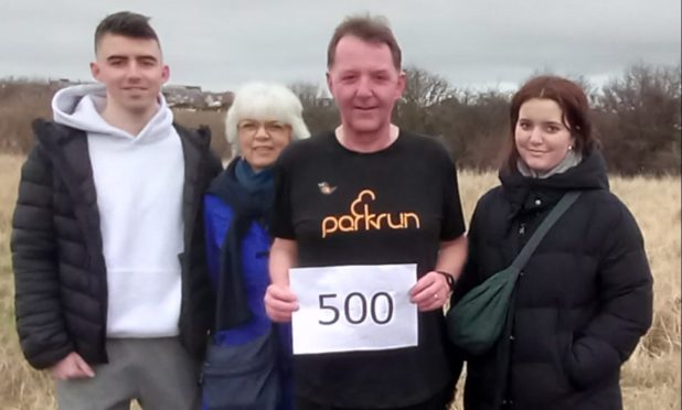 Bruce Clark, joined by nephew Matthew, wife Sarah and daughter Eleanor as he completed his 500th Parkrun along Aberdeen beach. Image: Bruce Clark.