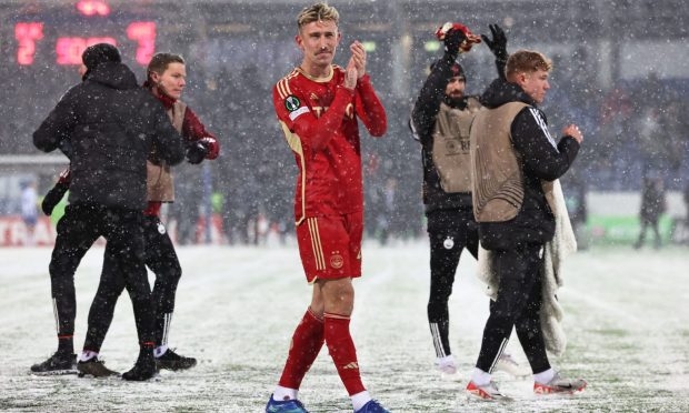 Aberdeen's Angus MacDonald applauds the Dons fans at full-time after the 2-2 Europa Conference League group stage match draw at HJK Helsinki. Image: SNS.