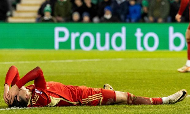 Aberdeen's Bojan Miovski lying on the ground with his head in his hands