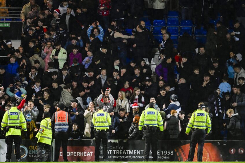 Police in Hi-Viz jackets during the pitch invasion after the Ross County v Dundee