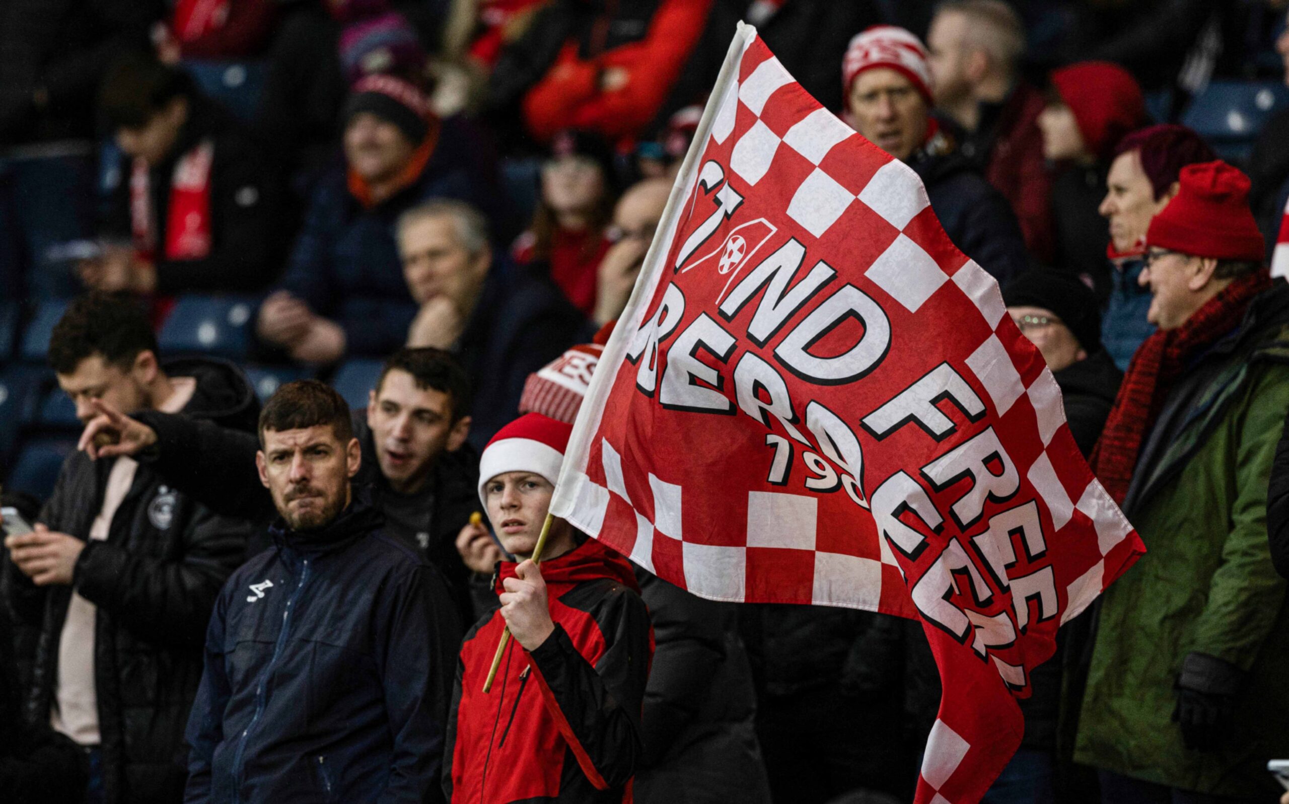 An Aberdeen fan with a Stand Free flag during the Viaplay Cup Final match against Rangers. Image: SNS 