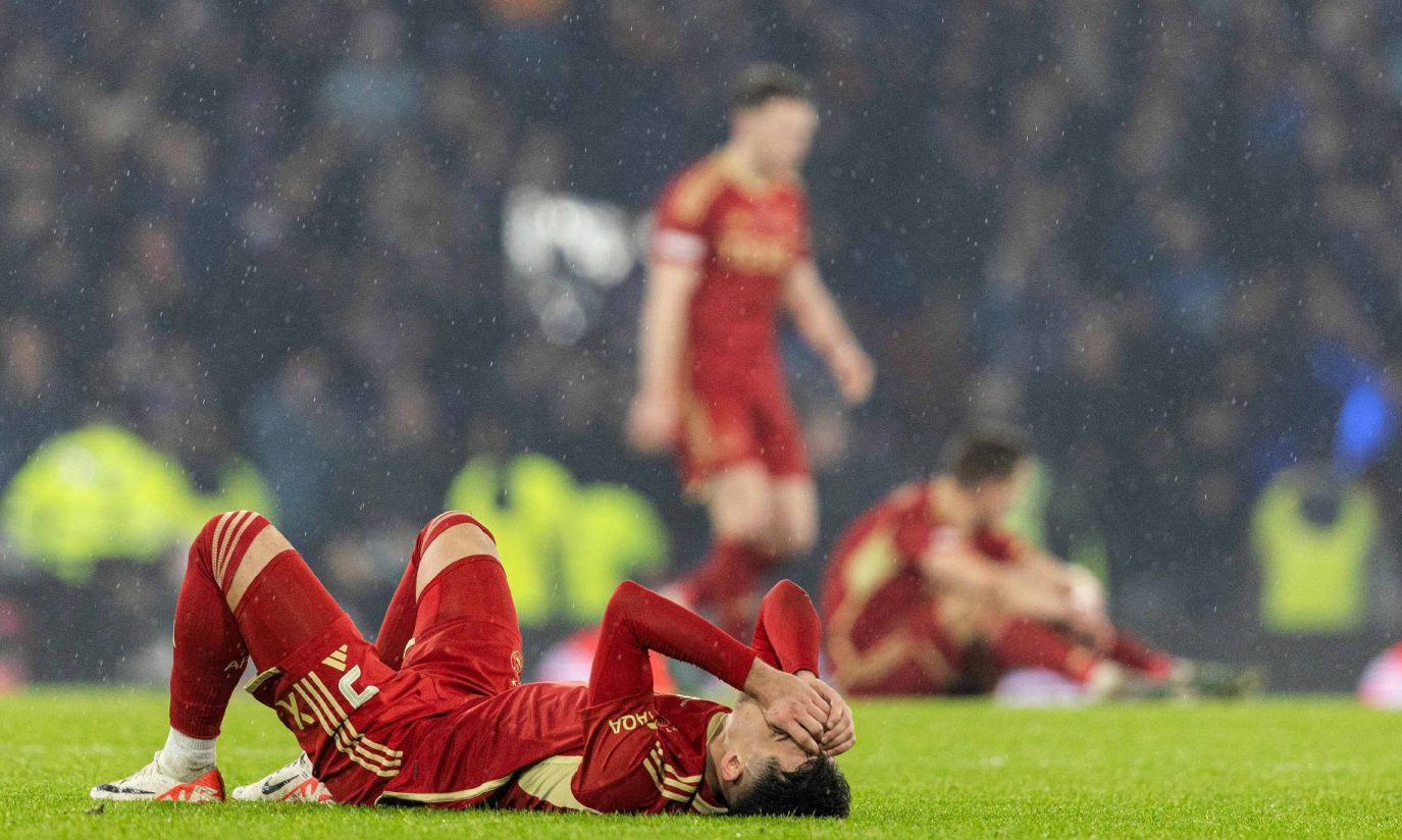 Aberdeen's Bojan Miovski lying on the pitch with his head in his hands