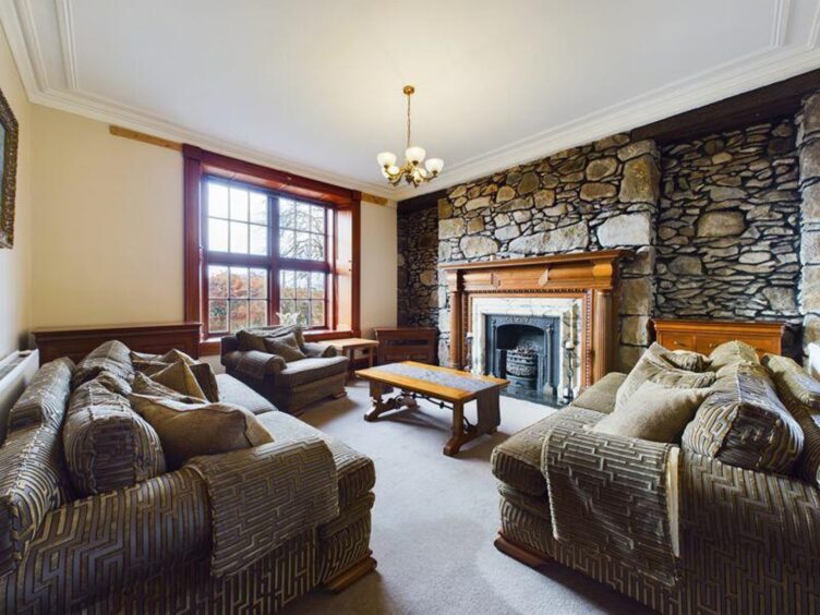 South Manse formal lounge with exposed granite wall