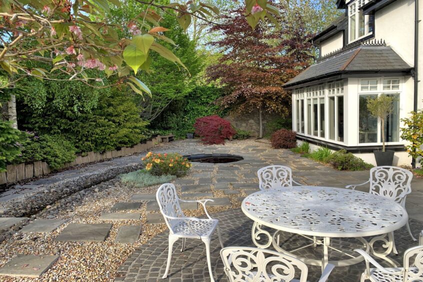 The garden and patio with white metal garden furniture