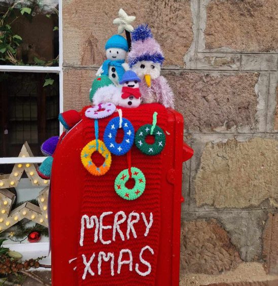 Crocheted postbox topper in Nairn.