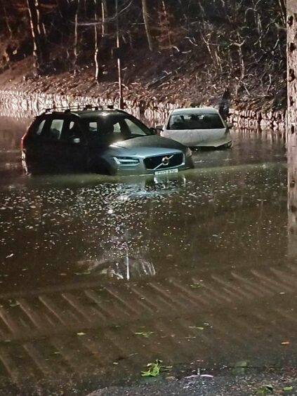 Cars stuck in flood water on Bogie Street in Huntly 