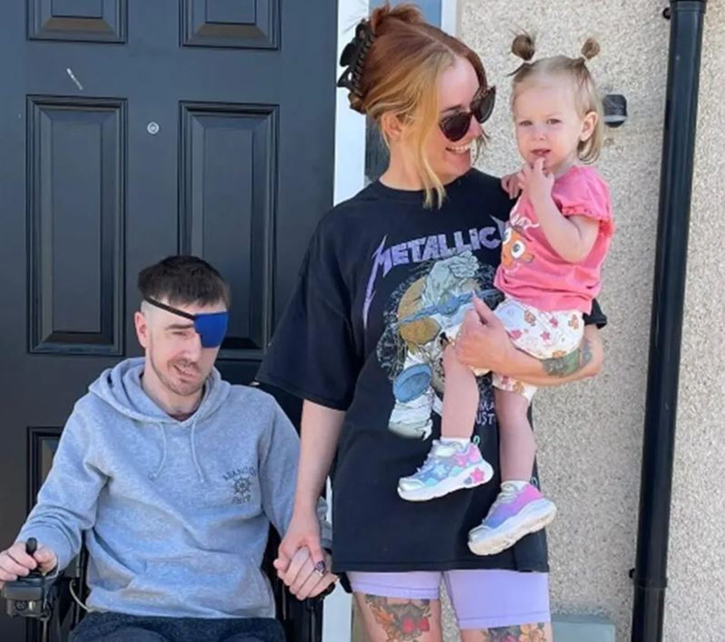 Andy Layton in wheelchair with wife Helen and daughter Lyra next to him. 