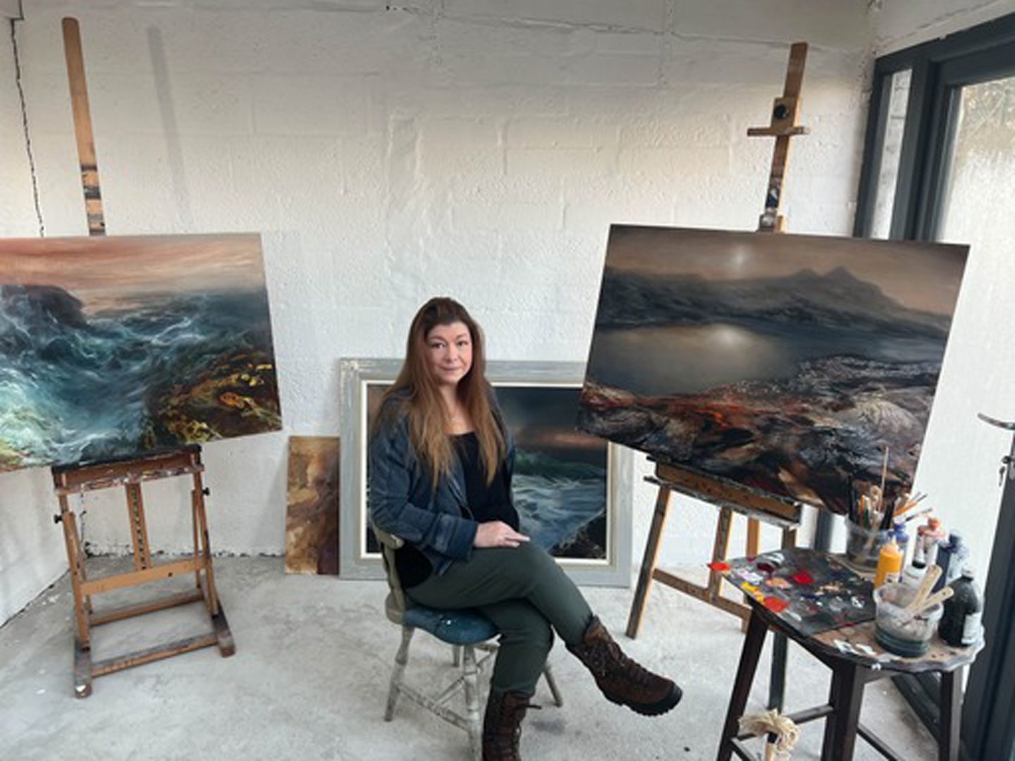 Beth Robertson Fiddes surrounded by paintings