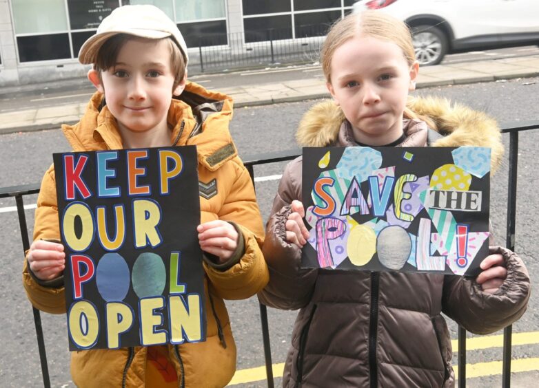 Child protestors against the closure of Bucksburn pool with signs reading: "Keep our pool open" and "Save the pool".