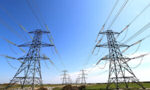 Pylons running through field.