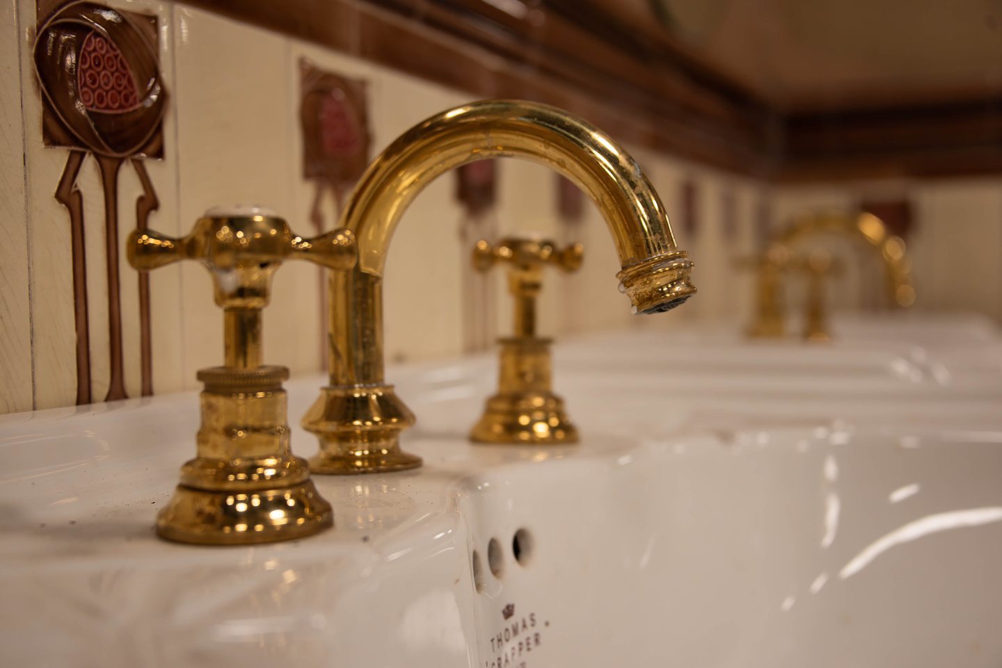 Golden ornate fixtures and fittings in the Victorian toilets