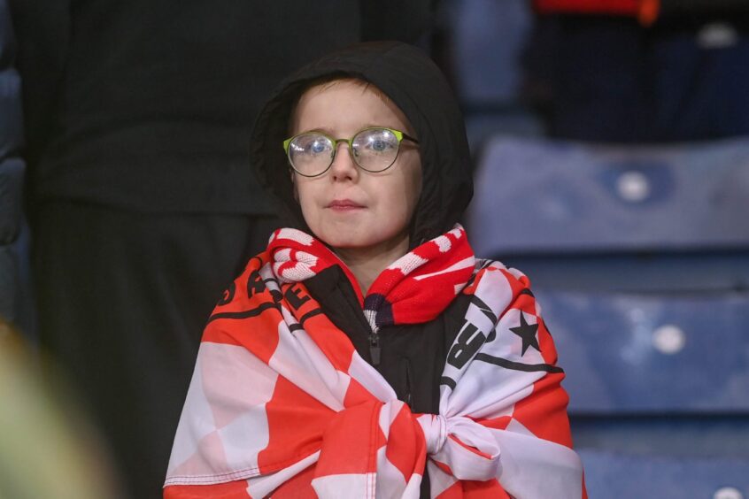 Young Dons fan watching the game at Hampden.