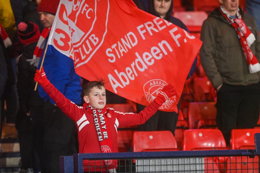 Youngster waves Dons flag.