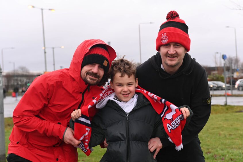 Two men and young boy in Aberdeen gear at Hampden Park for Viaplay Cup final